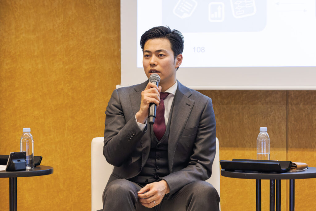 A man in a suit holding a microphone