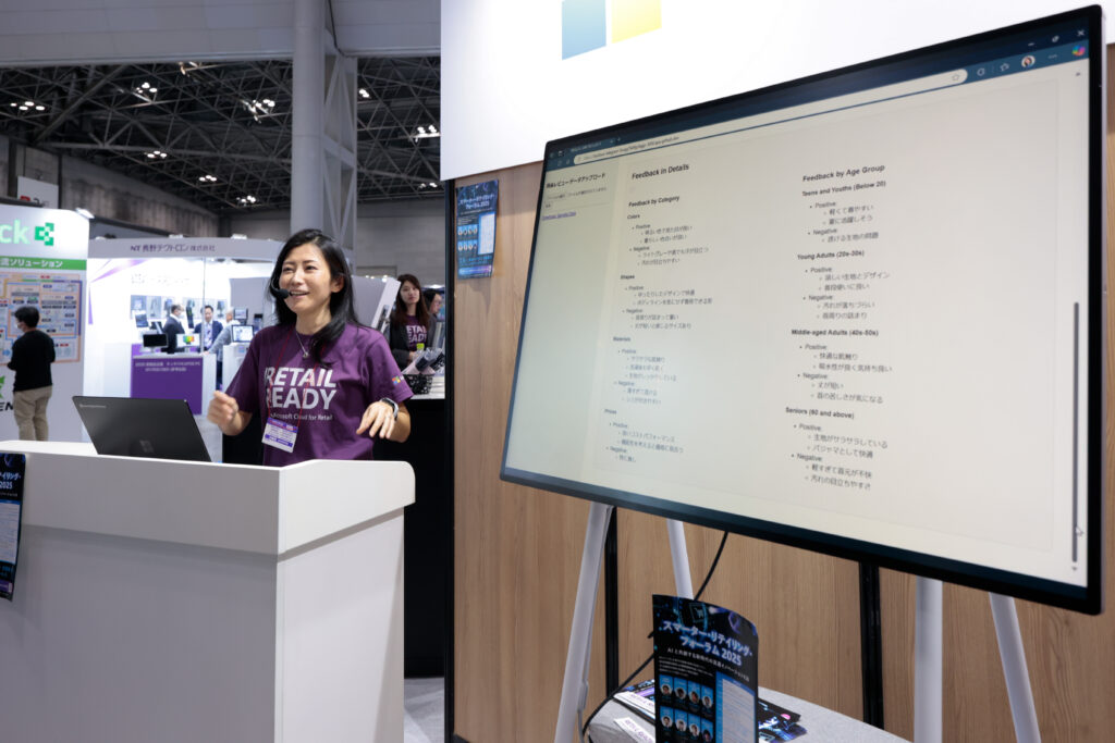 A woman standing at a podium with a screen