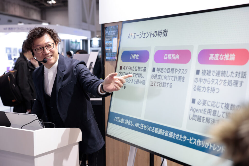 A man standing in front of a screen