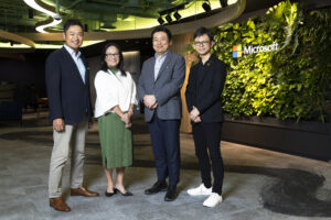 A group of people standing in front of Microsoft office reception