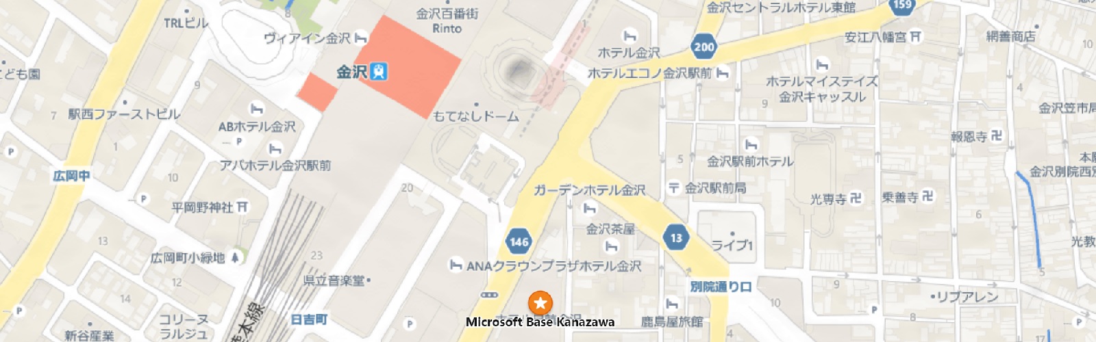 金沢市街地の地図で、道路、建物、鉄道が描かれており、「Microsoft Base Kanazawa」が星のピンで示されています。
