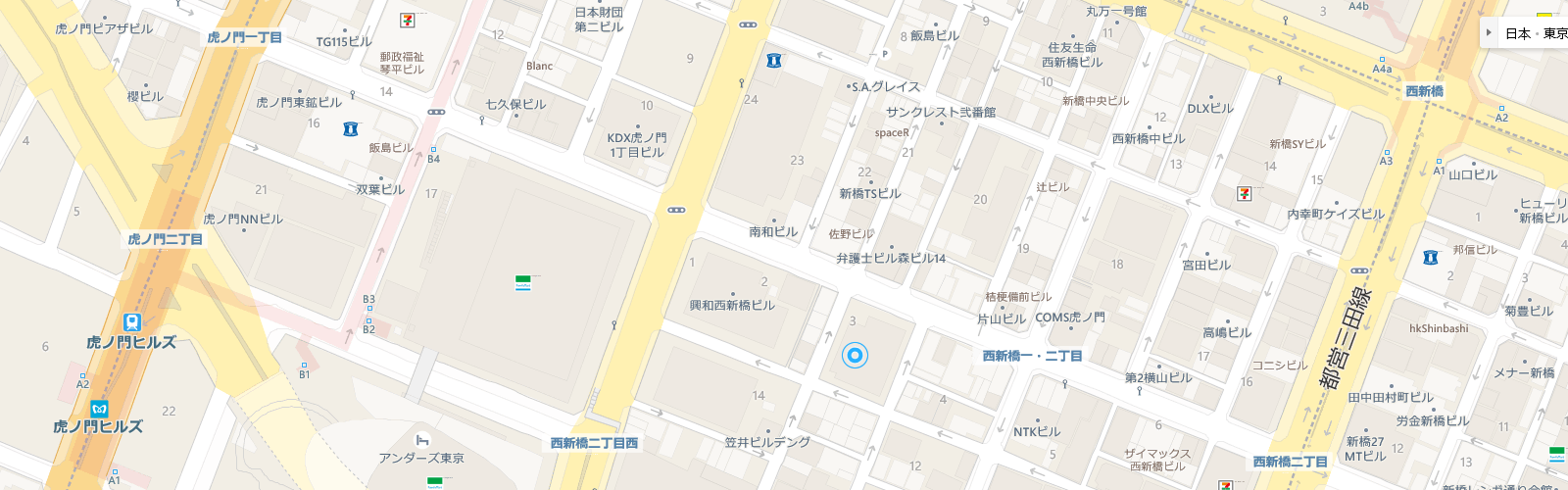 虎ノ門周辺の地図で、道路、建物が描かれ、中央に青い円のマーカーがあります。