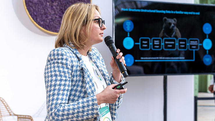 Woman smiling with a phone in her hand in the city.